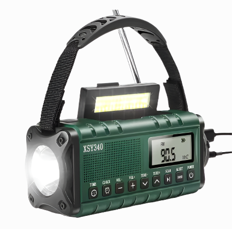 green emergency radio with flashlight on and USB cable connected, showing FM display and LED reading light