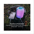 BioLite AlpenGlow 500 lantern displaying multicolour lighting modes outdoors
