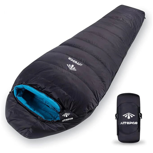 black sleeping bag with blue lining and compact compression sack