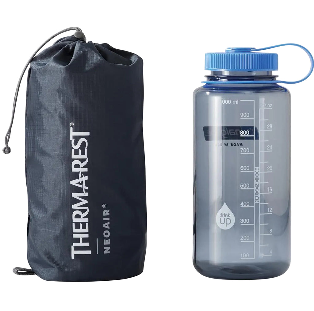 Packed Therm-a-Rest NeoAir XLite NXT sleeping pad with water bottle for size comparison